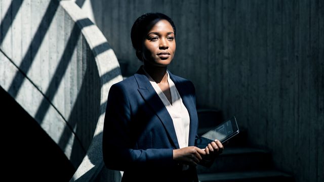 Jeune professionnelle consultant une interface d'identité numérique CONNECTELL sur tablette dans un bureau moderne